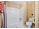 Cozy bathroom with a tub and shower combination and a classic white tile surround at 3436 Laurelwood Ne Ct, Roswell, GA 30075