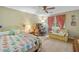 Cozy bedroom featuring a bed, desk, love seat and window with pink drapes at 3436 Laurelwood Ne Ct, Roswell, GA 30075