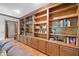 Detailed view of living room built-ins with cabinets and shelving for ample storage and display at 3436 Laurelwood Ne Ct, Roswell, GA 30075