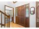 Inviting entryway featuring wood door with glass, hardwood floors, and view of the dining room at 3436 Laurelwood Ne Ct, Roswell, GA 30075