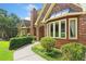 Charming brick home exterior with bay window, landscaped walkway, and manicured bushes under a beautiful sunny sky at 3436 Laurelwood Ne Ct, Roswell, GA 30075