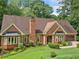Charming single-Gathering brick home with an attached garage, well-maintained lawn, and mature landscaping at 3436 Laurelwood Ne Ct, Roswell, GA 30075