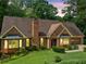 Charming single-Gathering brick home with an attached garage, well-maintained lawn, and mature landscaping at 3436 Laurelwood Ne Ct, Roswell, GA 30075