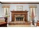 Stylish living room showcasing a brick fireplace, wood trim, natural light, and large windows at 3436 Laurelwood Ne Ct, Roswell, GA 30075