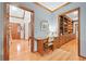 Inviting foyer featuring gleaming hardwood floors, custom millwork, and a functional built-in desk at 3436 Laurelwood Ne Ct, Roswell, GA 30075
