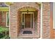 Charming brick archway leads to a solid wood front door, framed by sidelights at 3436 Laurelwood Ne Ct, Roswell, GA 30075