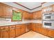 Well-lit kitchen with stainless appliances, wood floors and solid countertops at 3436 Laurelwood Ne Ct, Roswell, GA 30075