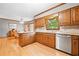 Kitchen with wood cabinetry, stainless appliances, and wood floors at 3436 Laurelwood Ne Ct, Roswell, GA 30075