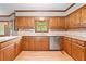 Charming kitchen with wood cabinets, solid countertops, stainless dishwasher and wood floors at 3436 Laurelwood Ne Ct, Roswell, GA 30075