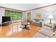 Bright living room features hardwood floors, large window and comfortable seating at 3436 Laurelwood Ne Ct, Roswell, GA 30075