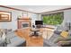 Inviting living room with a brick fireplace and large windows overlooking the yard at 3436 Laurelwood Ne Ct, Roswell, GA 30075