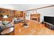 Spacious living room with hardwood floors, a fireplace, and custom built-in shelving at 3436 Laurelwood Ne Ct, Roswell, GA 30075