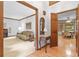 Living area featuring hardwood floors, wood trim, and a cozy sofa, leading into a bright dining area at 3436 Laurelwood Ne Ct, Roswell, GA 30075