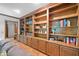 Spacious living room with custom wooden built-in bookshelves and cabinets at 3436 Laurelwood Ne Ct, Roswell, GA 30075