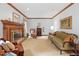 Comfortable living room featuring a fireplace, plush sofas, wood trim, carpet, and a decorative furniture pieces at 3436 Laurelwood Ne Ct, Roswell, GA 30075