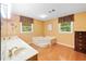 Bright main bathroom features a marble tub, separate vanities, and hardwood floors at 3436 Laurelwood Ne Ct, Roswell, GA 30075