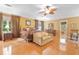 Spacious main bedroom features hardwood floors, a ceiling fan, and a comfortable seating area at 3436 Laurelwood Ne Ct, Roswell, GA 30075