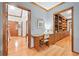 Hallway and office space with desk, built in book shelves, and hardwood floors, perfect for working at home at 3436 Laurelwood Ne Ct, Roswell, GA 30075