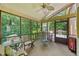 Comfortable screened porch with seating, views of the backyard, and ceiling fan for relaxing outdoors at 3436 Laurelwood Ne Ct, Roswell, GA 30075