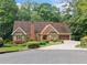 Charming single-Gathering brick home with an attached garage, well-maintained lawn, and mature landscaping at 3436 Laurelwood Ne Ct, Roswell, GA 30075