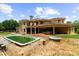 A sprawling backyard features a pool, hot tub, covered patio and lush landscaping at 932 Shadowford Fls, Lithonia, GA 30058