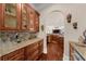 Stylish bar area with granite counters, glass cabinets, and decorative masks on the wall at 932 Shadowford Fls, Lithonia, GA 30058