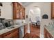 Charming bar area with custom cabinetry, granite countertops, and mosaic tile backsplash at 932 Shadowford Fls, Lithonia, GA 30058