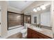 Bathroom features a shower and tub combination with glass doors, granite countertop, and a large mirror at 932 Shadowford Fls, Lithonia, GA 30058