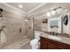 Modern bathroom featuring tile shower with glass doors, granite countertop, and large mirror at 932 Shadowford Fls, Lithonia, GA 30058