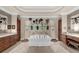 Bright bathroom showcases a soaking tub and arched shower with views of the outdoor scenery at 932 Shadowford Fls, Lithonia, GA 30058