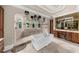 Bright bathroom showcases a soaking tub and arched shower with views of the outdoor scenery at 932 Shadowford Fls, Lithonia, GA 30058