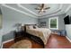 Bedroom with ceiling fan, hardwood floors, large bed, and access to the outside at 932 Shadowford Fls, Lithonia, GA 30058