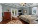 Charming bedroom features a ceiling fan, hardwood floors, and a door to a private balcony at 932 Shadowford Fls, Lithonia, GA 30058