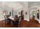 Dining room with wood floors, elegant table and chairs, tray ceiling, and decorative wall accents at 932 Shadowford Fls, Lithonia, GA 30058
