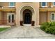 Elegant entrance with an arched doorway and beautifully decorated wrought iron double doors and two decorative pots at 932 Shadowford Fls, Lithonia, GA 30058
