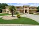 Expansive two-story home featuring a circular driveway with mature landscaping and an elegant Mediterranean-style exterior at 932 Shadowford Fls, Lithonia, GA 30058