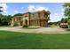 Beautiful two-story home with a Mediterranean-style exterior, a well-manicured lawn, and ample parking space at 932 Shadowford Fls, Lithonia, GA 30058