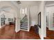 Elegant foyer with hardwood floors, arched doorways, a staircase, and fireplace at 932 Shadowford Fls, Lithonia, GA 30058