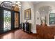 Elegant foyer with hardwood floors, arched doorways, decorative doors, and a view of the staircase at 932 Shadowford Fls, Lithonia, GA 30058