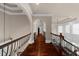 Upstairs hallway with hardwood floors and wrought iron railing at 932 Shadowford Fls, Lithonia, GA 30058