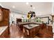 Spacious gourmet kitchen features granite counters, wood floors, and a pot rack over the island at 932 Shadowford Fls, Lithonia, GA 30058