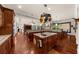 Open-concept gourmet kitchen featuring granite countertops, island sink, dark wood cabinets, and stainless appliances at 932 Shadowford Fls, Lithonia, GA 30058