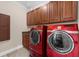 Modern laundry room with red Samsung washer and dryer at 932 Shadowford Fls, Lithonia, GA 30058
