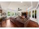 Expansive living room with hardwood floors, large windows, and custom media console at 932 Shadowford Fls, Lithonia, GA 30058