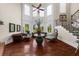 Elegant living room showcasing tall windows, wood floors, detailed trim, and an open staircase at 932 Shadowford Fls, Lithonia, GA 30058