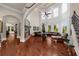 Spacious living room with hardwood floors, high ceilings, fireplace, and an array of large windows at 932 Shadowford Fls, Lithonia, GA 30058