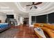 Open concept living area with hardwood floors, fireplace, modern sofa, and wet bar at 932 Shadowford Fls, Lithonia, GA 30058