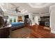 Spacious main bedroom with hardwood floors, fireplace, wet bar, tray ceiling, and access to balcony at 932 Shadowford Fls, Lithonia, GA 30058