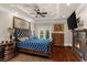 Spacious main bedroom with hardwood floors, fireplace, tray ceiling, and access to balcony at 932 Shadowford Fls, Lithonia, GA 30058