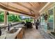 Covered outdoor kitchen with built-in grill and sink for convenient entertaining with wood ceiling at 932 Shadowford Fls, Lithonia, GA 30058